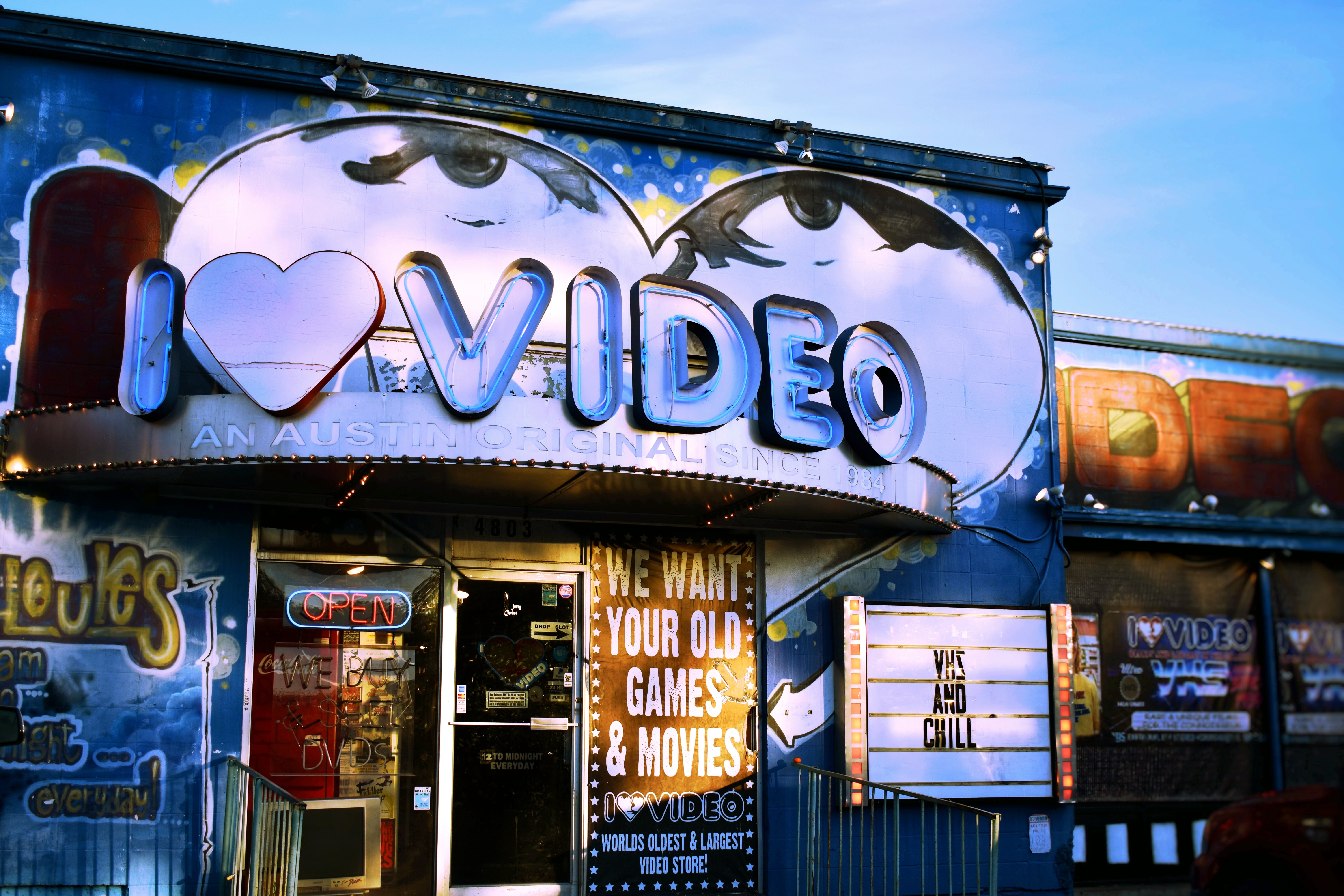 A video store front with signs